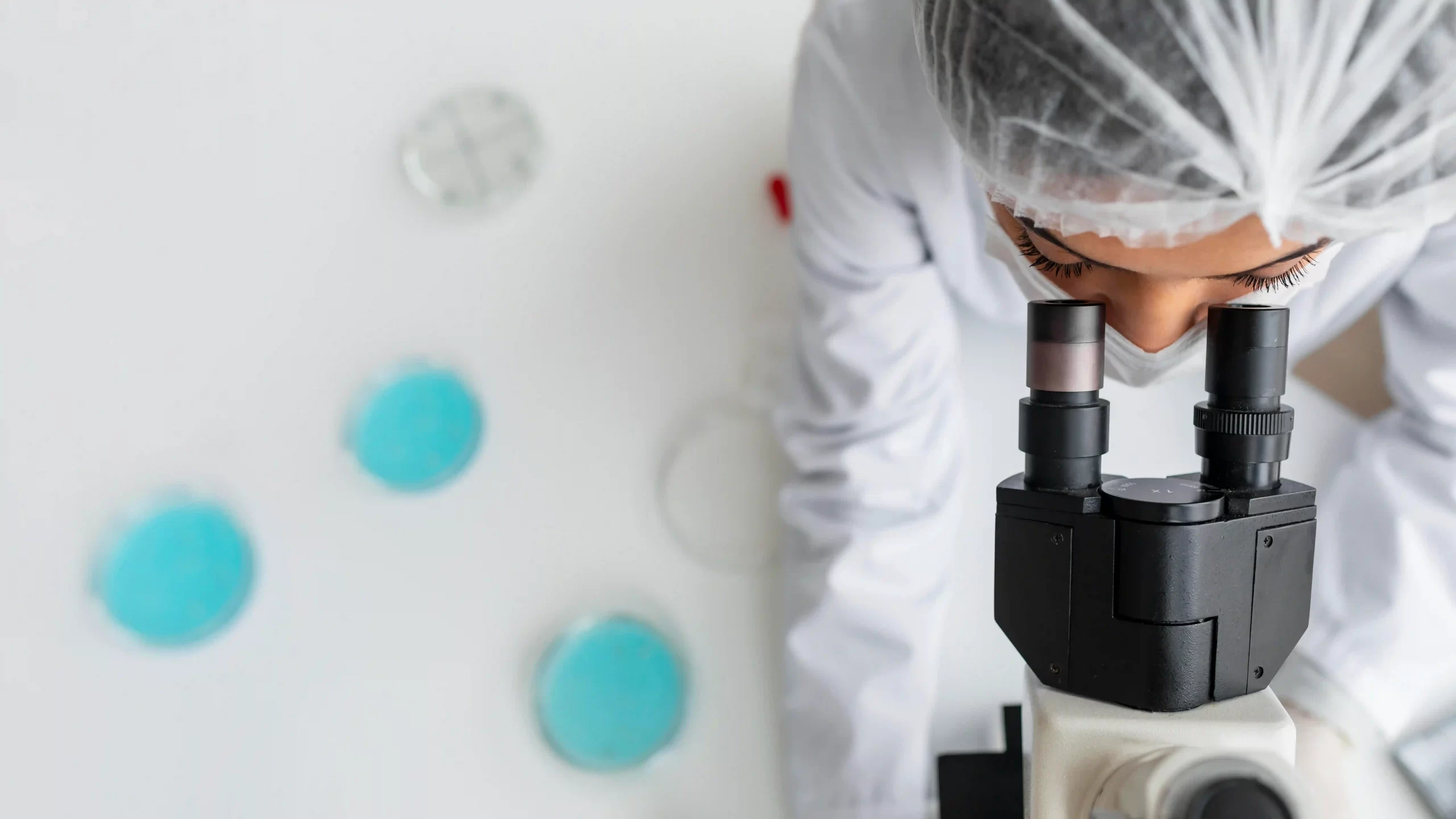 1-close-up-researcher-looking-through-ocular-lens-scaled