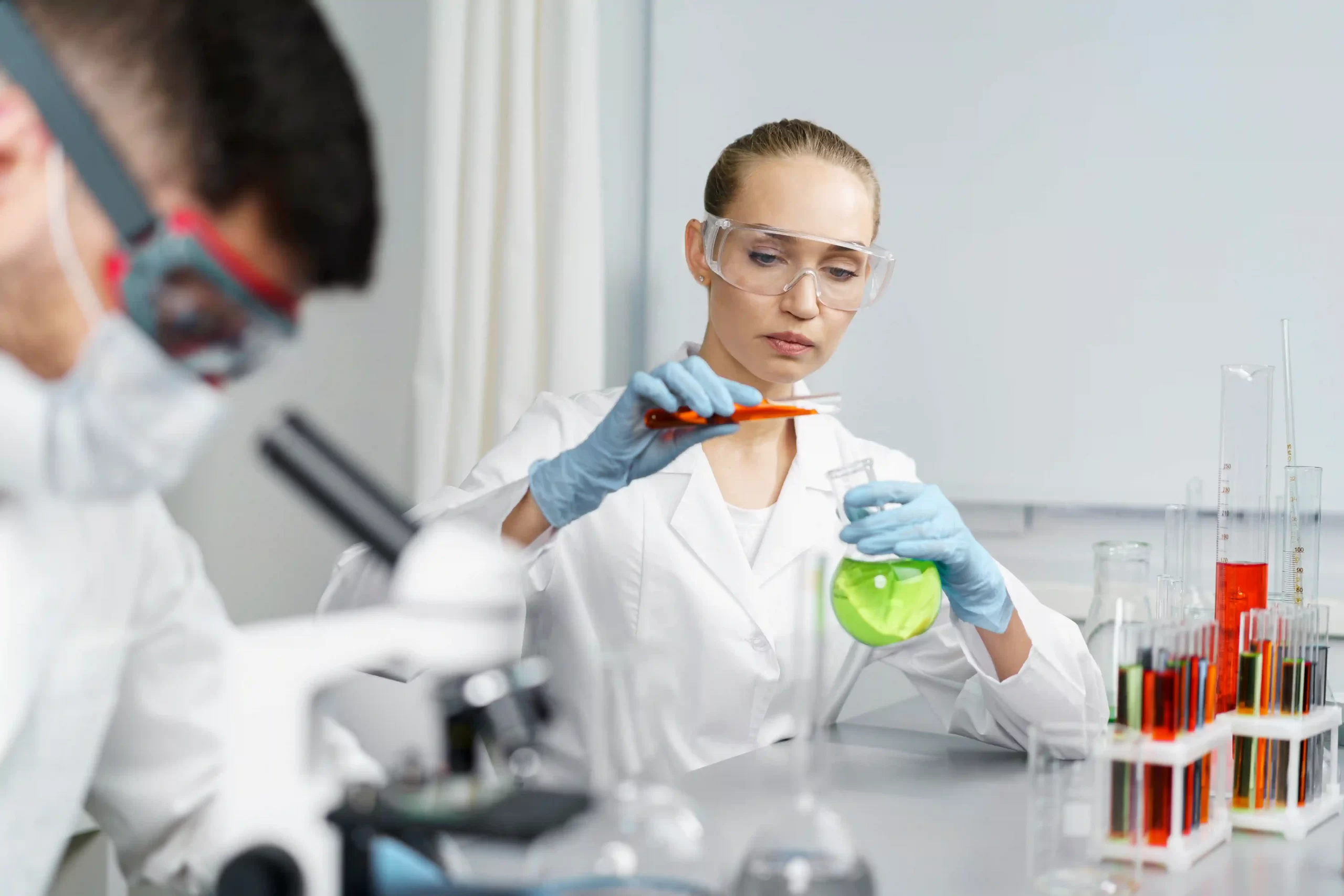 1 female-researcher-laboratory-with-test-tubes-male-colleague