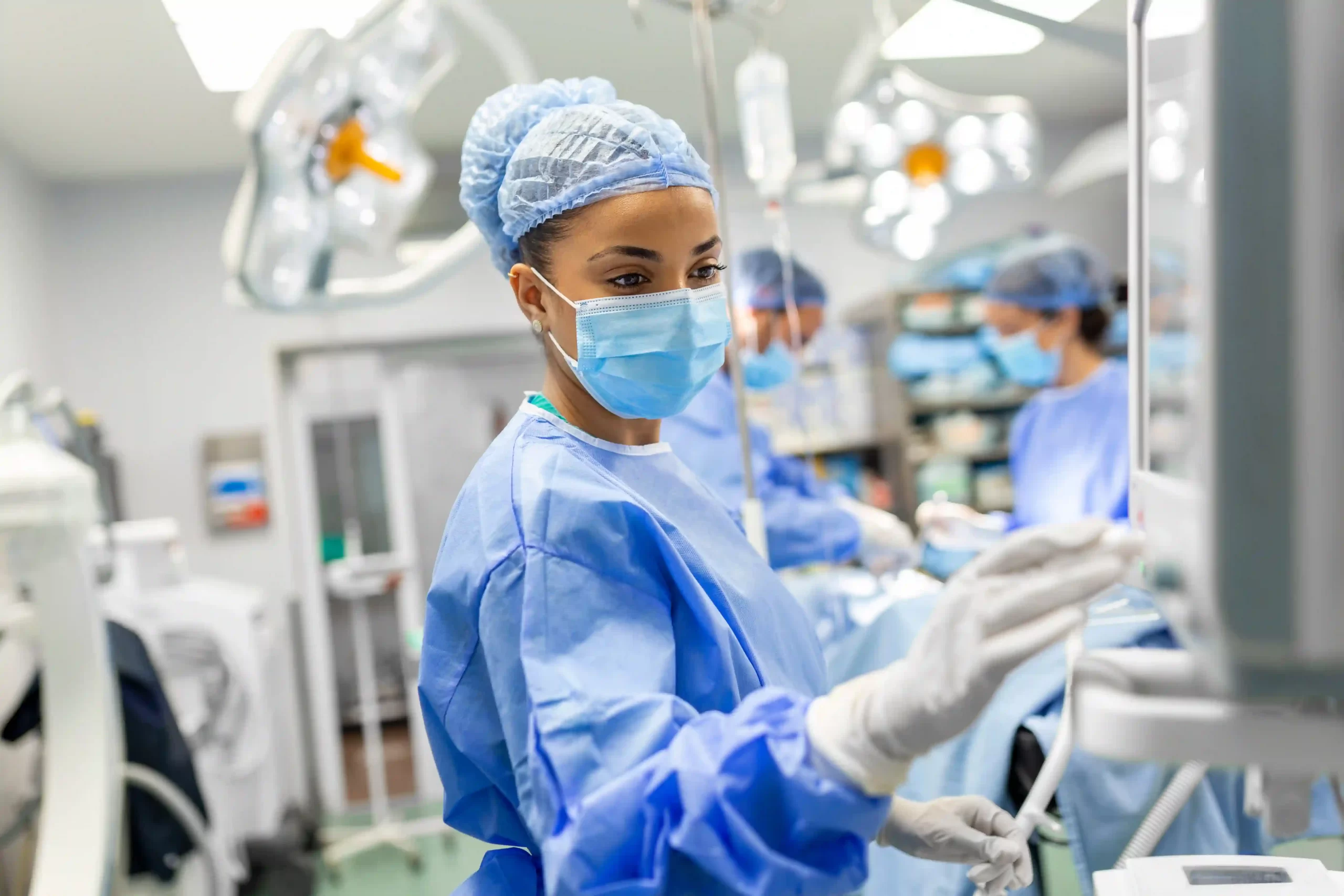 1female-doctor-scrubs-protective-face-mask-preparing-anesthesia-machine-before-operation